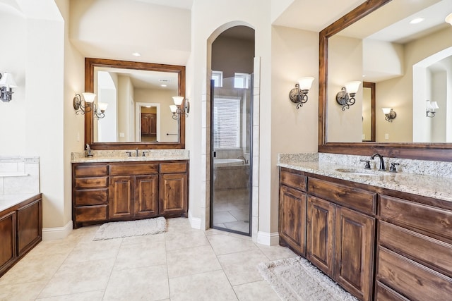 bathroom with tile patterned flooring, vanity, and a shower with door