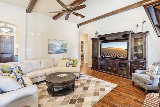 living room featuring wood-type flooring, beam ceiling, and ceiling fan