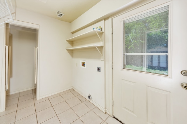 clothes washing area featuring washer hookup, electric dryer hookup, and light tile patterned floors