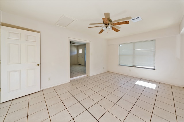 tiled empty room with ceiling fan