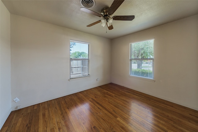 unfurnished room with ceiling fan, hardwood / wood-style floors, and a textured ceiling