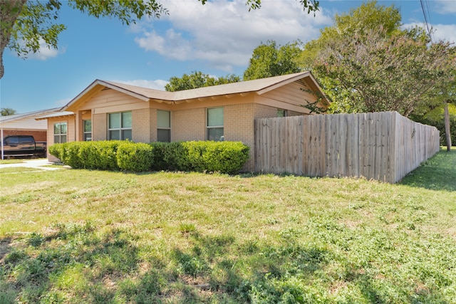 view of side of home with a lawn