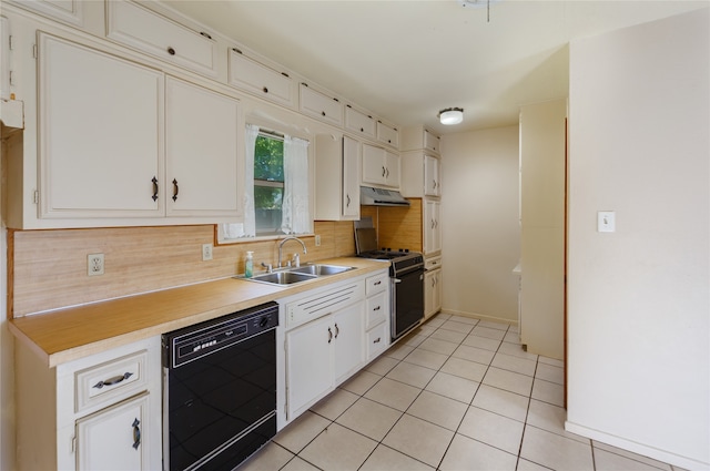 kitchen featuring light tile patterned flooring, sink, white cabinetry, black appliances, and decorative backsplash