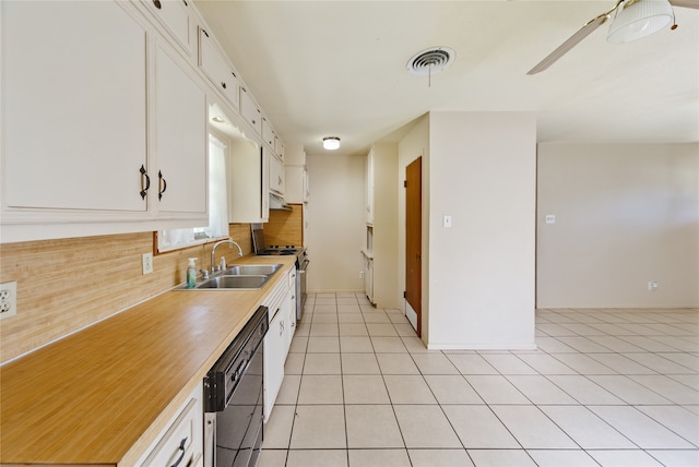 kitchen with light tile patterned floors, sink, white cabinetry, appliances with stainless steel finishes, and decorative backsplash