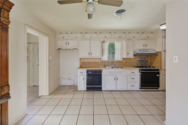 kitchen with sink, white cabinets, backsplash, black appliances, and light tile patterned floors