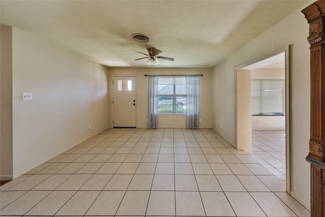 tiled foyer with ceiling fan