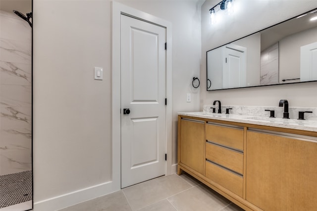 bathroom with a shower, tile patterned flooring, and vanity