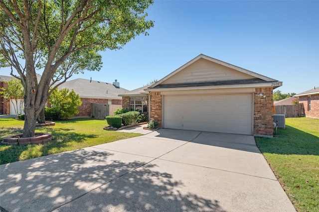 ranch-style house featuring a garage, central AC unit, and a front yard