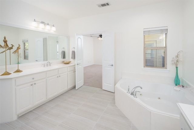 bathroom with tile patterned flooring, vanity, a bathtub, and ceiling fan