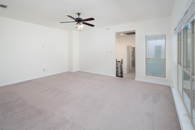 carpeted spare room featuring ceiling fan