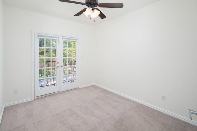 carpeted empty room with ceiling fan and french doors