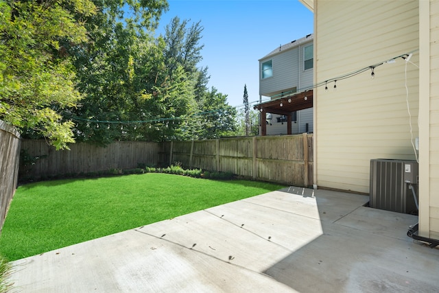 view of yard with a patio and central AC