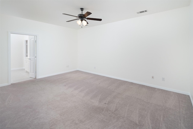 spare room featuring ceiling fan and light colored carpet