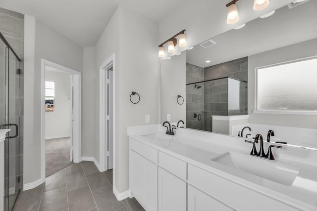 bathroom featuring tile patterned flooring, vanity, and an enclosed shower