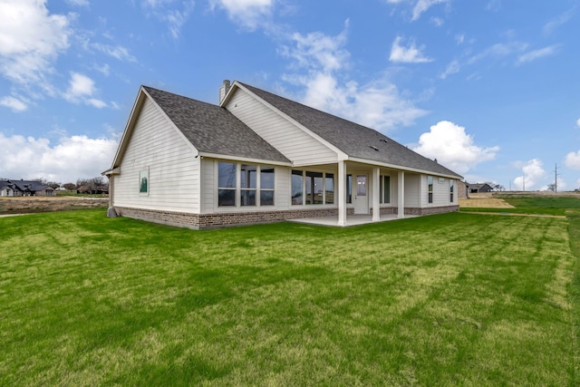 back of property featuring a yard and a patio