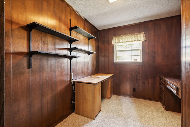 unfurnished office featuring wood walls and a textured ceiling