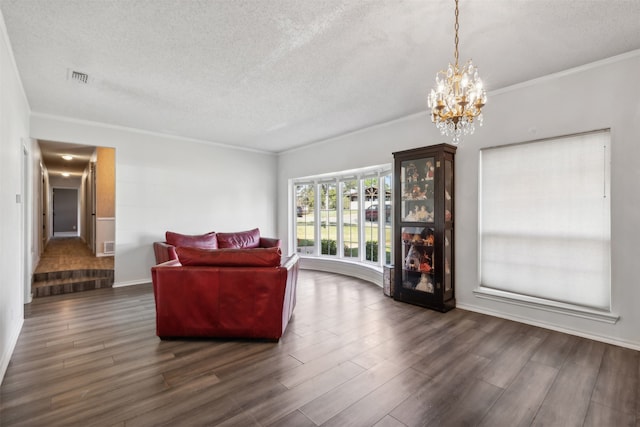 living room with dark hardwood / wood-style floors, a chandelier, and a textured ceiling