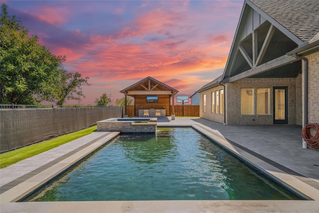 pool at dusk with a patio