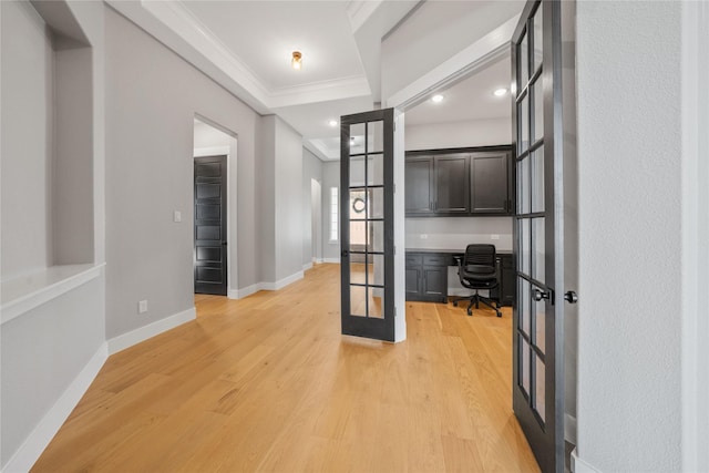 office space with ornamental molding, french doors, and light wood-type flooring