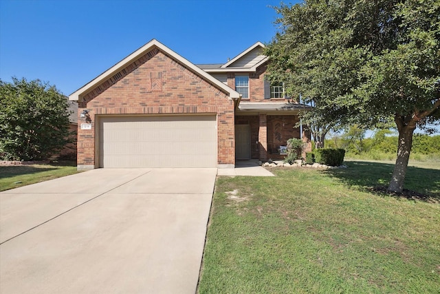 view of front of home featuring a front yard and a garage