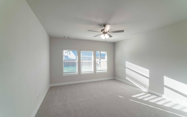 carpeted empty room featuring ceiling fan