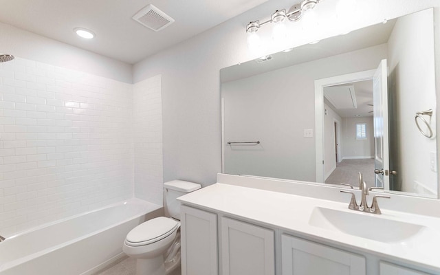 full bathroom featuring tile patterned floors, vanity, tiled shower / bath combo, and toilet