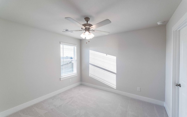 spare room featuring ceiling fan and light colored carpet