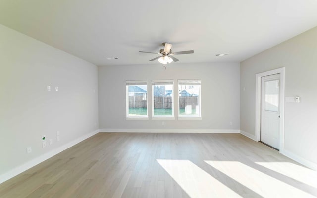 spare room with light hardwood / wood-style floors and ceiling fan