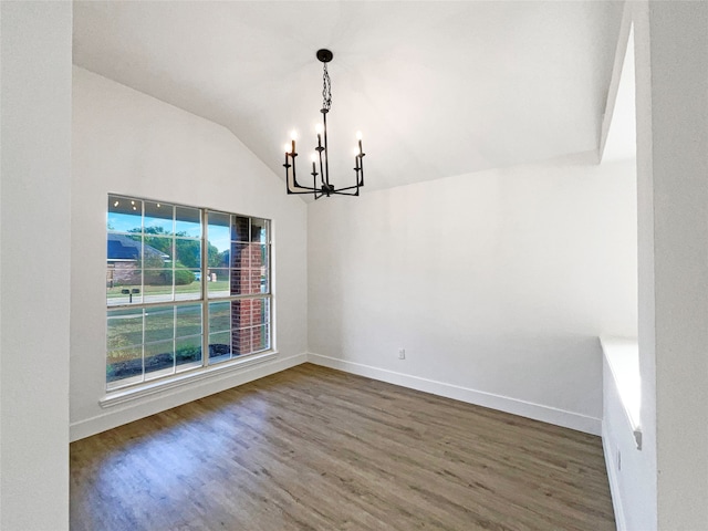 unfurnished dining area with a notable chandelier, lofted ceiling, and dark wood-type flooring