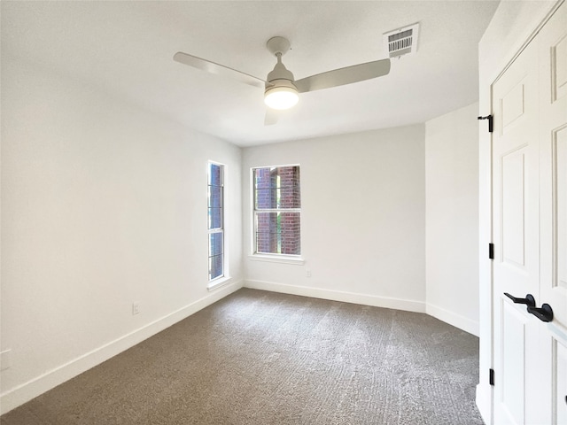 unfurnished room featuring ceiling fan and carpet flooring