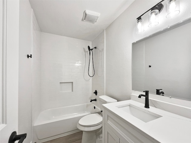 full bathroom featuring tiled shower / bath, vanity, toilet, and hardwood / wood-style flooring