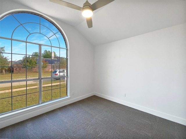 carpeted spare room featuring lofted ceiling and ceiling fan