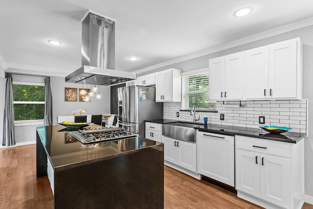 kitchen featuring island range hood, hardwood / wood-style flooring, appliances with stainless steel finishes, and white cabinetry