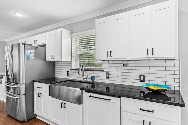 kitchen featuring white cabinets, stainless steel fridge, sink, dark hardwood / wood-style floors, and crown molding