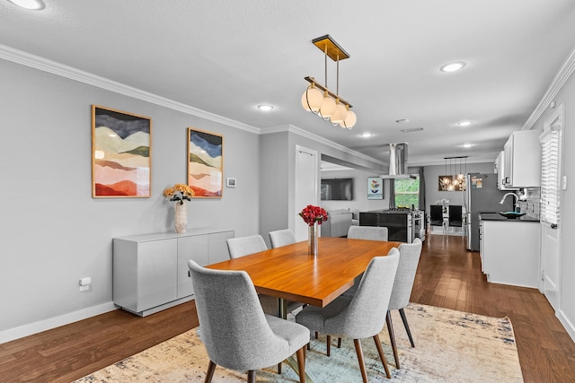 dining area featuring crown molding, dark hardwood / wood-style flooring, and sink