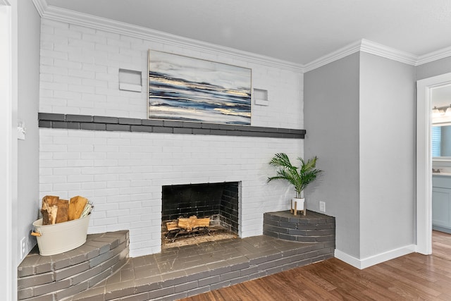 details featuring wood-type flooring, crown molding, and a brick fireplace