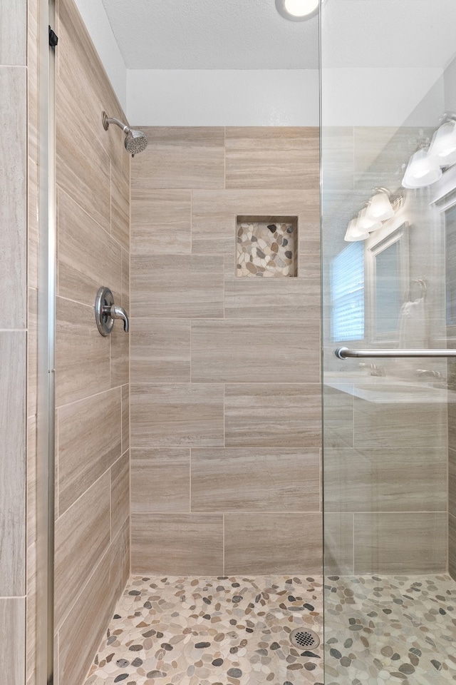 bathroom with tiled shower