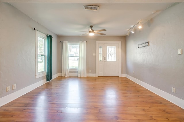 entrance foyer featuring light hardwood / wood-style flooring, ceiling fan, and rail lighting