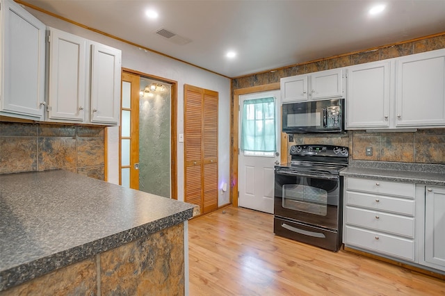 kitchen with light hardwood / wood-style floors, tasteful backsplash, white cabinetry, black appliances, and ornamental molding