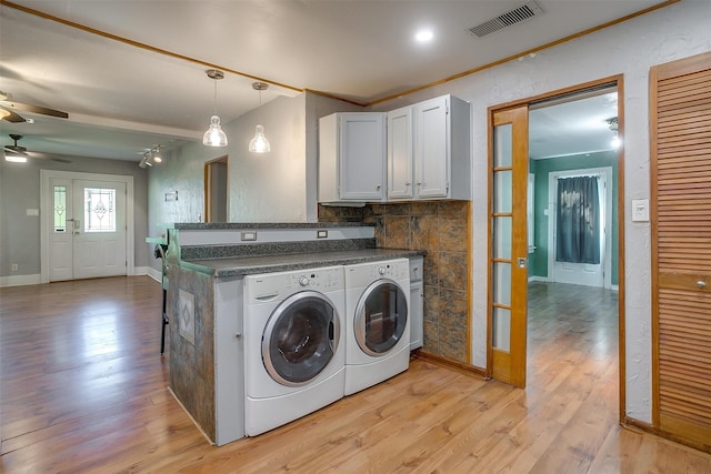 laundry room with ceiling fan, light hardwood / wood-style floors, and washer and dryer