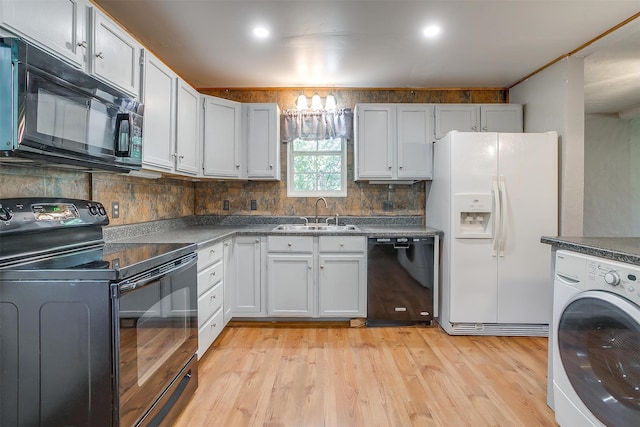 kitchen featuring black appliances, sink, washer / dryer, and white cabinets