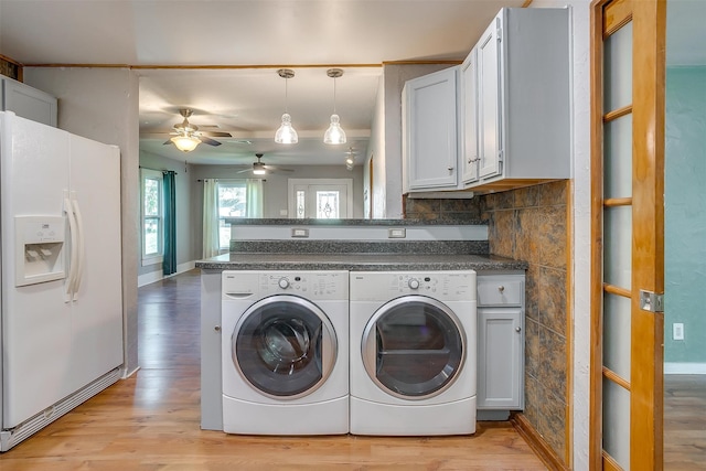 washroom with washing machine and clothes dryer, ceiling fan, and light hardwood / wood-style flooring