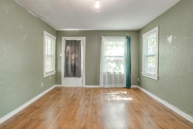 empty room with light hardwood / wood-style floors