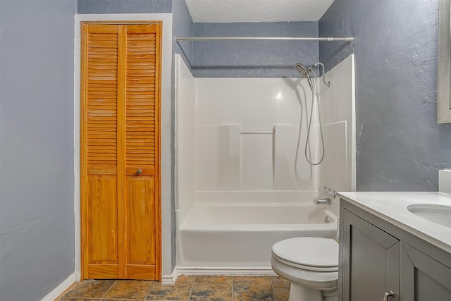 full bathroom featuring washtub / shower combination, vanity, and toilet