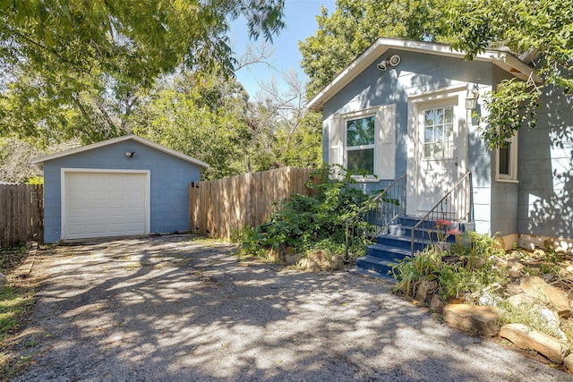 view of front of property with an outdoor structure and a garage