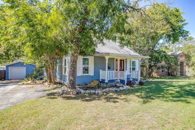 view of front of property featuring a front yard, an outdoor structure, a porch, and a garage