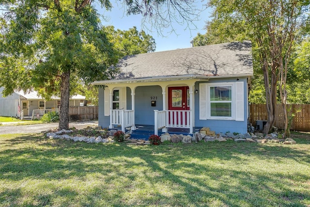 bungalow-style home featuring a porch and a front lawn