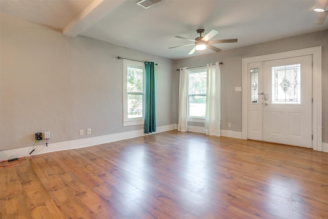 foyer entrance with ceiling fan and light hardwood / wood-style flooring