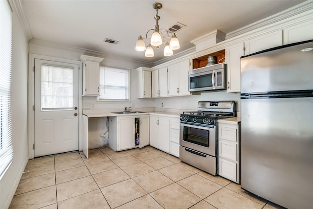 kitchen featuring white cabinetry, hanging light fixtures, stainless steel appliances, light tile patterned floors, and ornamental molding