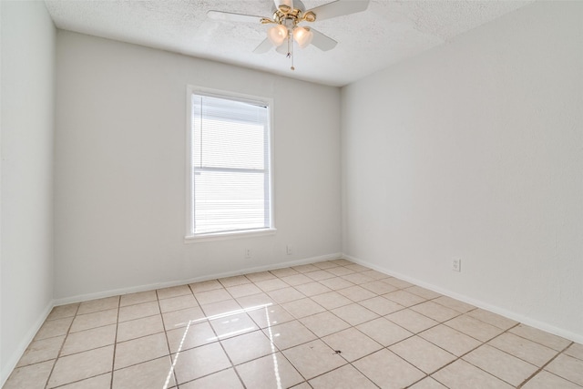 tiled spare room with a textured ceiling and ceiling fan